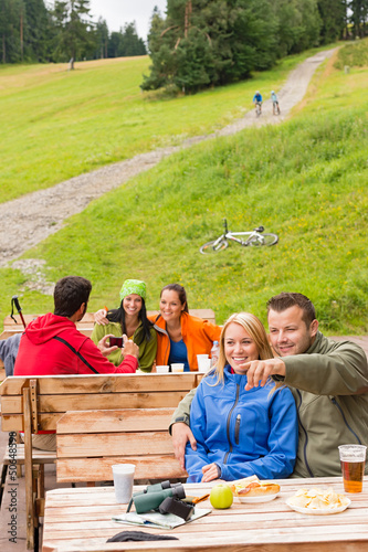 Photo: Young tourists in nature sitting bench Young tourists in nature sitting bench
