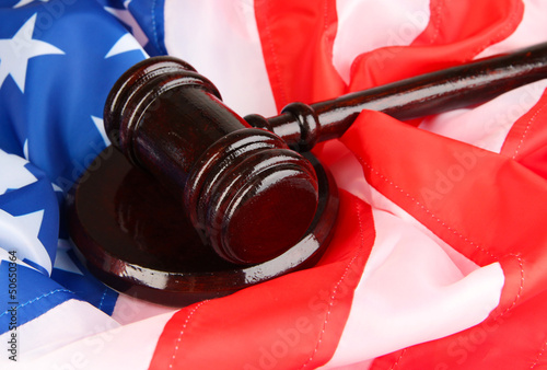 Photo: Judge gavel on american flag background Judge gavel on american flag background