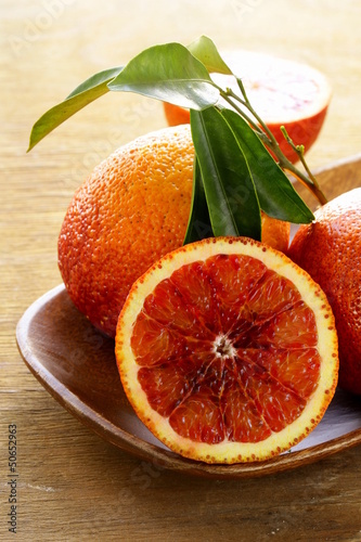 Photo: red (bloody) oranges on a wooden background red (bloody) oranges on a wooden background