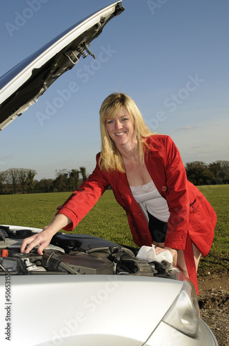 Photo: female motorist with car bonnet raised female motorist with car bonnet raised