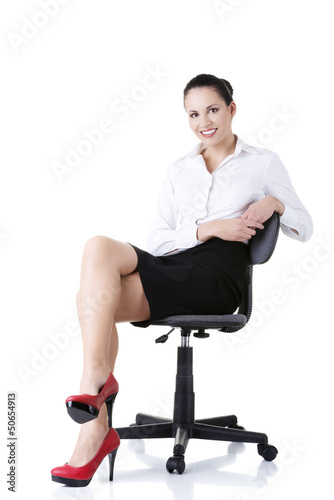 Photo: Businesswoman sitting on ofice chair Businesswoman sitting on ofice chair