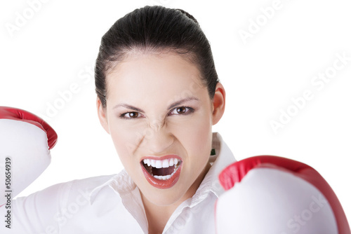 Photo: Young businesswoman with boxing gloves Young businesswoman with boxing gloves