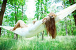 Young woman lying in a hammock on resort