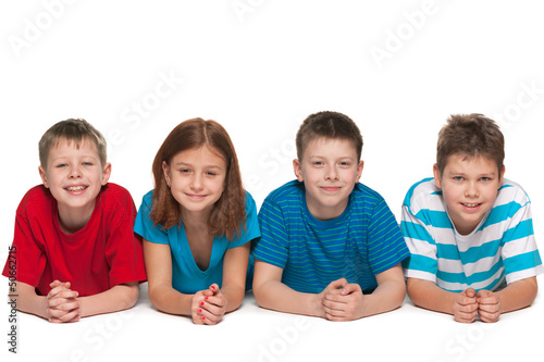 Photo: Four kids are lying on the floor Four kids are lying on the floor