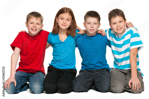 Photo: Four children are sitting on the floor Four children are sitting on the floor