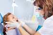 Dentist examining kid's teeth