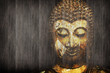 Ancient Buddha face on wood background