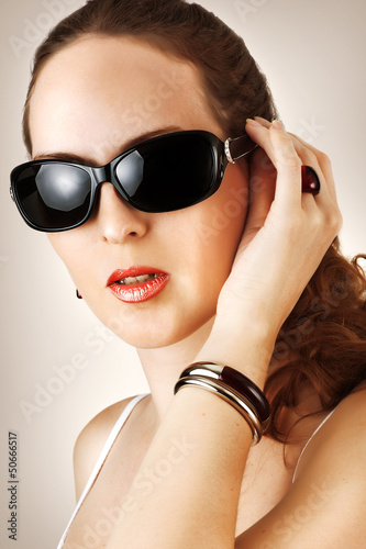 Photo: Young woman with fahion black glasses Young woman with fahion black glasses