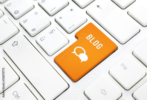 Photo: Blog business concept, text and icon. Orange key on a keyboard Blog business concept, text and icon. Orange key on a keyboard