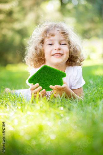 Photo: Child holding eco house Child holding eco house