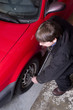 Photo: Auto Technician Uses Breaker Bar Loosening Lug Nuts on Car Auto Technician Uses Breaker Bar Loosening Lug Nuts on Car