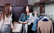 Two girlfriends are joking while do shopping at the store