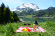 Wine and vegetables served at a picnic in Alpine meadow. Switzer
