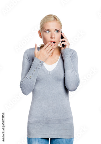 Photo: Speaking on phone shocked woman covers her mouth with hand Speaking on phone shocked woman covers her mouth with hand