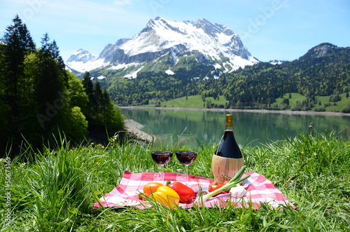 Photo: Wine and vegetables served at a picnic in Alpine meadow. Switzer Wine and vegetables served at a picnic in Alpine meadow. Switzer