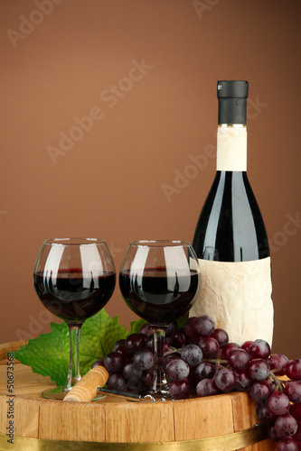 Photo: Composition of wine bottle, glasses and grape,on wooden Composition of wine bottle, glasses and grape,on wooden