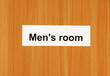 Toilet sign on wooden background