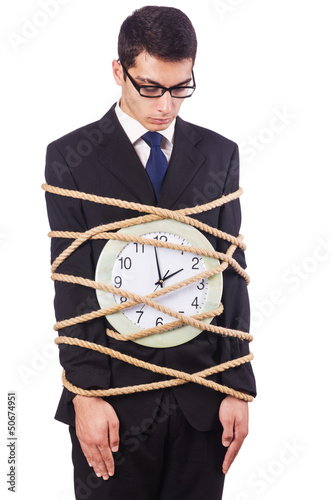 Photo: Businessman tied to clock on white Businessman tied to clock on white