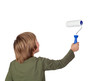 Adorable child with a paint roller
