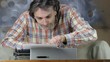 Busy man typing on old typewriting machine