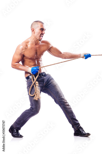 Photo: Muscular man pulling the rope Muscular man pulling the rope