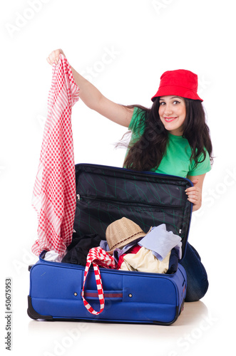 Photo: Young girl packing for vacation Young girl packing for vacation