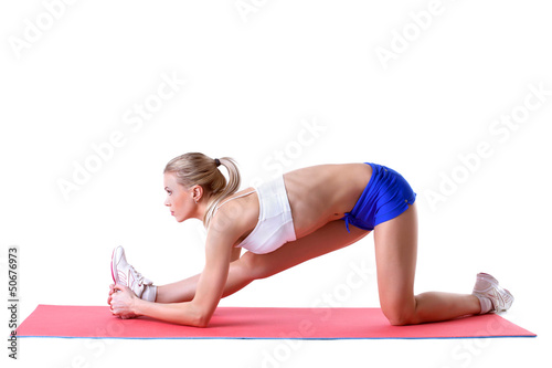Photo: Pretty blonde doing aerobics exercises on mat Pretty blonde doing aerobics exercises on mat