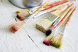 Paint brush and can on white planks