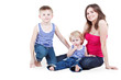 Foto: Mother and two sons in striped singlets sit on floor Mother and two sons in striped singlets sit on floor
