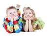 Little boy and girl in carnival suits lie on their stomachs