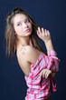 Beautiful smiling girl in removed in half pink plaid shirt looks
