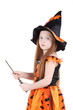 Girl in orange costume of witch for Halloween holds wand