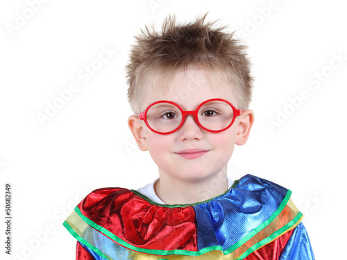 Photo: Cute little boy in big red glasses and clown costume isolated Cute little boy in big red glasses and clown costume isolated