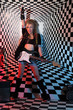 Photo: Young woman with electric guitar sings in studio Young woman with electric guitar sings in studio