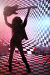 Photo: Silhouette of girl holding electric guitar overhead in studio Silhouette of girl holding electric guitar overhead in studio