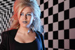 Young woman with unusual hairdo and makeup looks into distance