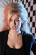 Young woman with unusual hairdo and makeup sings in studio