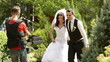 Wedding film maker in action, taking a picture of the bride and