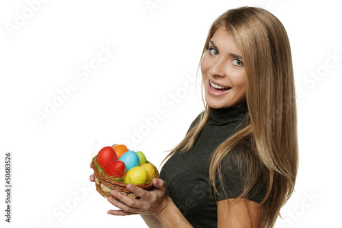 Photo: Smiling woman holding basket with Easter eggs Smiling woman holding basket with Easter eggs