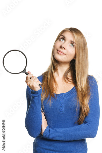 Photo: Pensive young female holding magnifying glass Pensive young female holding magnifying glass