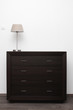 brown commode with lamp in bright minimalism interior