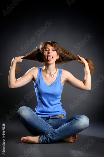 Photo: Girl sitting in the lotus position in jeans Girl sitting in the lotus position in jeans
