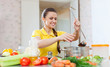 young woman salts the soup