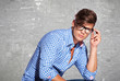 Fashion young man holding his glasses
