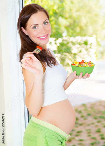 Photo: Happy pregnant woman eating Happy pregnant woman eating