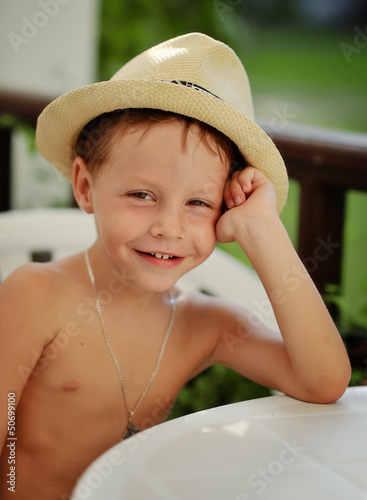 Photo: hot summer day poses little boy in straw hat hot summer day poses little boy in straw hat