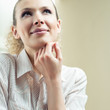 Photo: Young smiling blond woman thinking Young smiling blond woman thinking