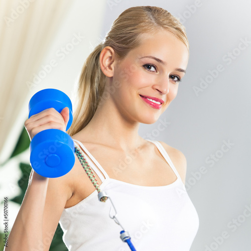 Photo: Woman exercising with dumbbells and growth Woman exercising with dumbbells and growth