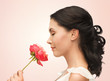 smiling woman smelling flower