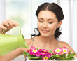 housewife with flower in pot and watering can